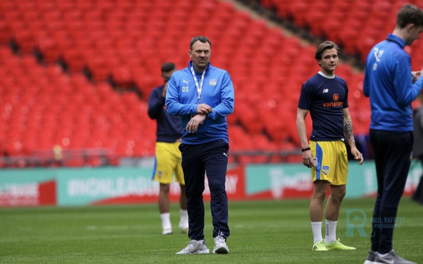Danny Scopes walking the Wembley pitch in his Concord Rangers tracksuit before the FA Trophy final
